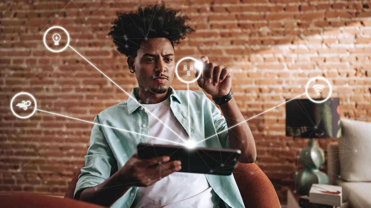 A illustrative photo of a man clicking an icon in the air coming from his digital tablet