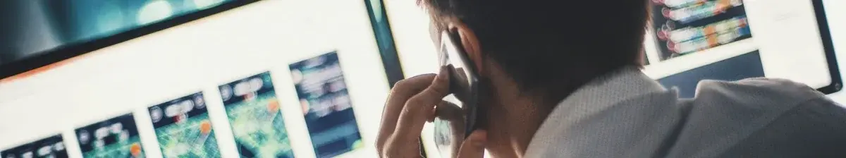 Security Performance homme au téléphone devant un ordinateur