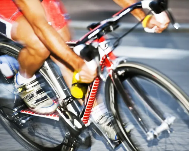 Close-up of a racing cyclist in motion, illustrating speed of threat detection and response