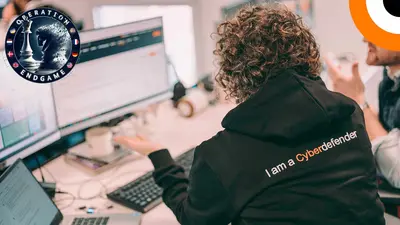 An Orange Cyberdefense employee working at a computer workstation.