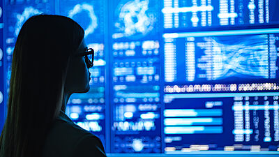 Woman looking at a wall of data