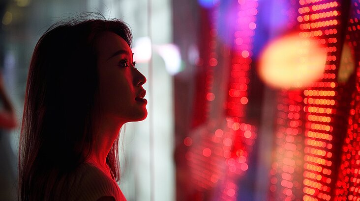 woman standing in front of a light wall