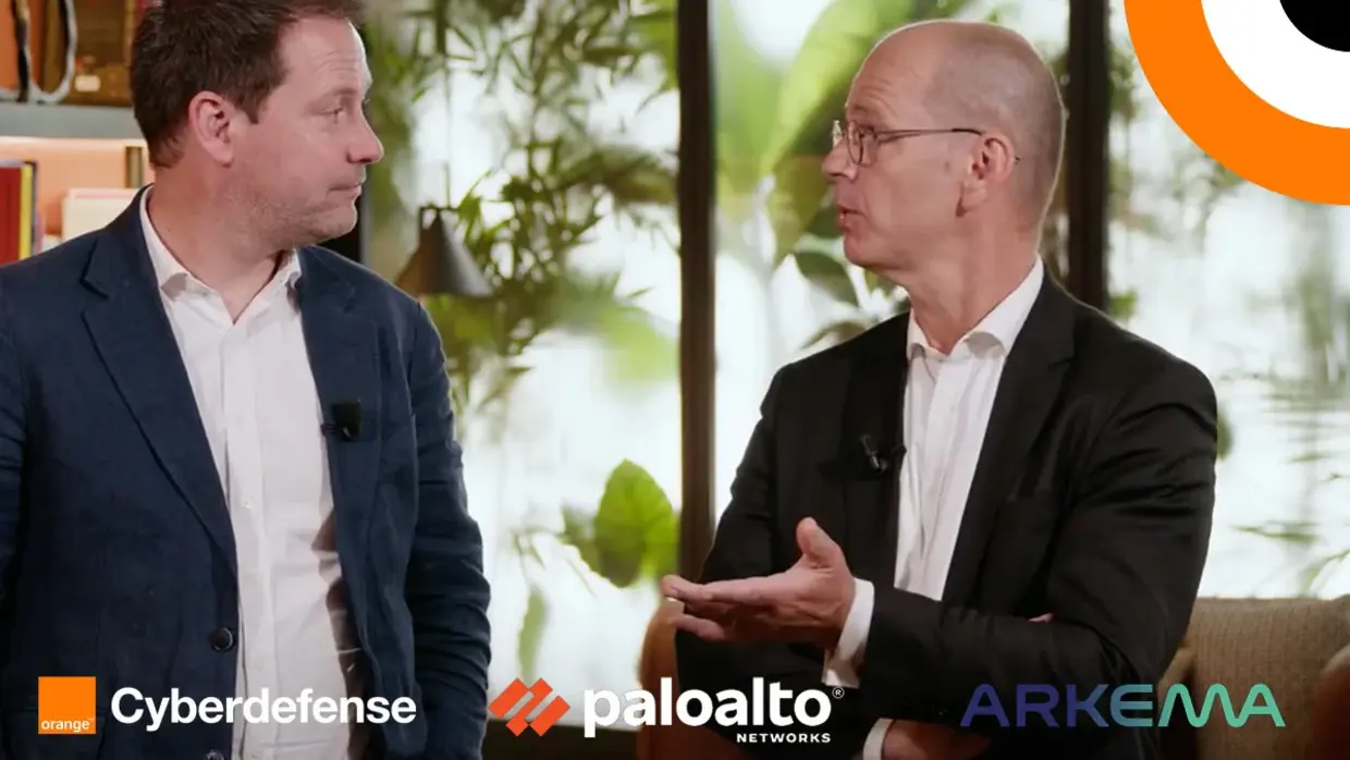 Orange Cyberdefense protège Arkema en s'appuyant sur la solution XSIAM. Deux hommes échangent en étant debout l'un à côté de l'autre.