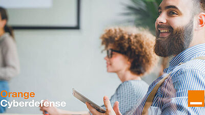 Orange Cyberdefense branded image of a man and a woman seen from the side