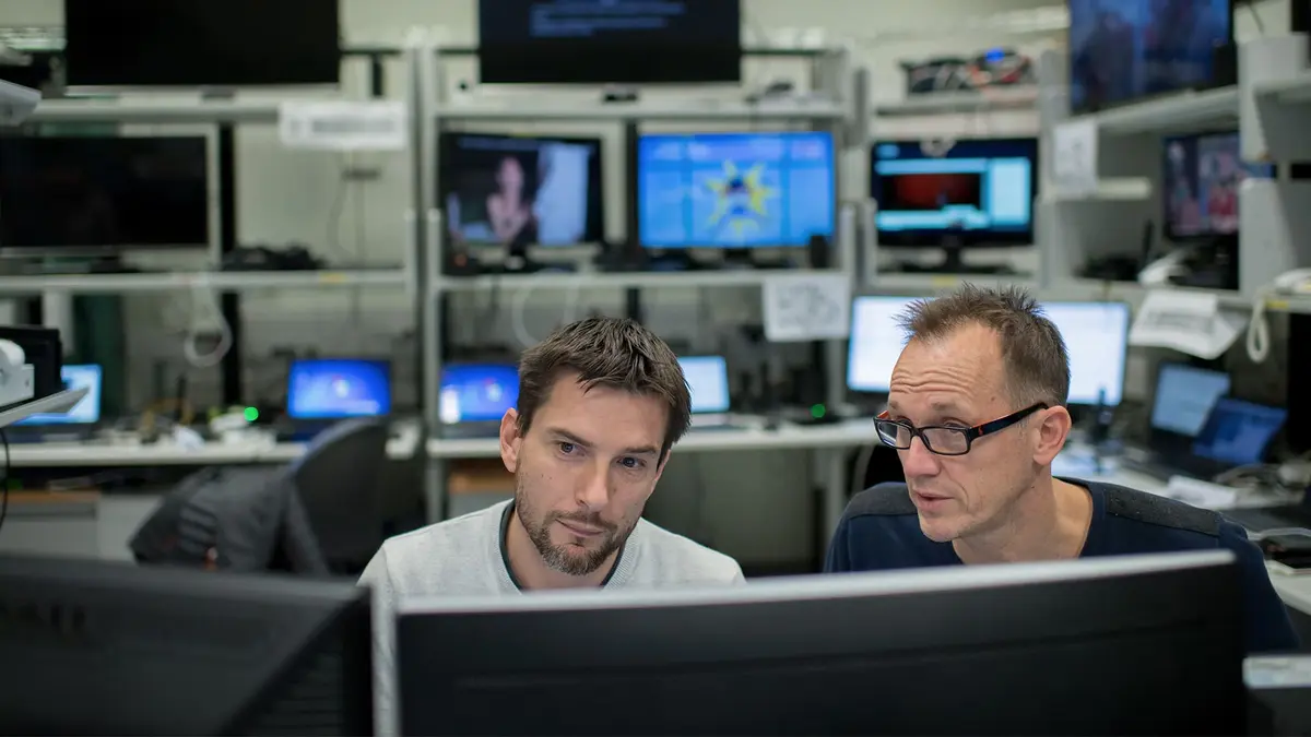 Two experts in cybersecurity working together